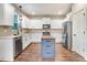 Open kitchen featuring white cabinets, stainless steel appliances, and a blue kitchen island with butcher block top at 130 Stromness Path, Clayton, NC 27527