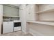 A laundry room featuring a washer and dryer, white cabinets, and shelves at 130 Stromness Path, Clayton, NC 27527