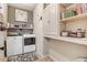 Functional laundry room with modern washer and dryer, shelving, and storage cabinets at 130 Stromness Path, Clayton, NC 27527