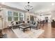 Spacious living room with a large sectional sofa and a view of the kitchen at 130 Stromness Path, Clayton, NC 27527