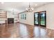 Spacious living room featuring a fireplace, custom built-ins, and French doors to the backyard at 130 Stromness Path, Clayton, NC 27527