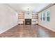 Spacious living room featuring a fireplace, custom built-ins, and windows with natural light at 130 Stromness Path, Clayton, NC 27527