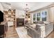 Comfortable living room showcasing built-in shelves, modern decor, and a cozy fireplace at 130 Stromness Path, Clayton, NC 27527
