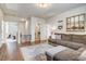 Inviting living room boasts a cozy brown sofa, wood floors, and stylish decor at 130 Stromness Path, Clayton, NC 27527