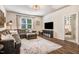 Comfortable living room with a sectional sofa, a large window, and a TV at 130 Stromness Path, Clayton, NC 27527