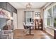 Well-lit office space with hardwood floors, a modern desk, and a cozy seating area for a productive work environment at 130 Stromness Path, Clayton, NC 27527