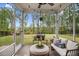 Relaxing screened-in patio with comfortable seating and views of the backyard at 130 Stromness Path, Clayton, NC 27527