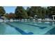 A view of the community swimming pool with lounge chairs and umbrellas at 130 Stromness Path, Clayton, NC 27527