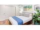 Comfortable bedroom features a large bed, closet, stylish decor, and a sunny window at 1309 Hudson Ave # D1, Durham, NC 27705