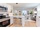 Open floor plan showcasing the kitchen and living room with modern furnishings and decor at 1309 Hudson Ave # D1, Durham, NC 27705