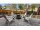 Backyard patio with a cozy fire pit surrounded by chairs, perfect for outdoor entertaining at 1320 Heritage Hills Way, Wake Forest, NC 27587