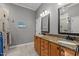 Spacious bathroom with double vanities, granite counters, and stylish mirrors and lights at 1320 Heritage Hills Way, Wake Forest, NC 27587