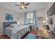 Cozy bedroom featuring a bed, desk, ceiling fan, and natural light at 1320 Heritage Hills Way, Wake Forest, NC 27587