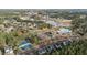 Aerial view showcasing the community's amenities, including a pool, tennis courts, and surrounding residential neighborhood at 1320 Heritage Hills Way, Wake Forest, NC 27587