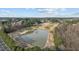Scenic aerial shot of the golf course showcasing the tranquil pond, manicured fairways, and surrounding mature trees at 1320 Heritage Hills Way, Wake Forest, NC 27587