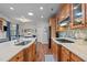 Well-lit kitchen featuring wooden cabinets, stainless steel appliances, and marble countertops at 1320 Heritage Hills Way, Wake Forest, NC 27587