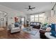 Open-concept living room with multiple seating areas, a large window, and seamless access to the kitchen at 1320 Heritage Hills Way, Wake Forest, NC 27587