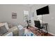 Well-lit office space with comfortable seating, desk, and exercise bike near a sunny window at 1320 Heritage Hills Way, Wake Forest, NC 27587