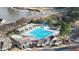 Aerial view of a community pool featuring a slide, lounge area, and smaller pool for residents' enjoyment at 1320 Heritage Hills Way, Wake Forest, NC 27587