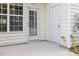 Covered back patio with a door leading to the interior of the home and an additional outdoor storage closet at 135 Cedar Elm Rd, Durham, NC 27713