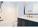 Bathroom featuring a vanity, updated fixtures, a shower-tub combo, and light blue walls at 135 Cedar Elm Rd, Durham, NC 27713