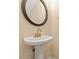 Elegant half bathroom with a round mirror and brushed gold faucet at 135 Cedar Elm Rd, Durham, NC 27713