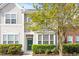 Charming townhome with a green door and well-manicured landscaping at 135 Cedar Elm Rd, Durham, NC 27713