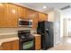 Functional kitchen with wooden cabinets and modern appliances at 135 Cedar Elm Rd, Durham, NC 27713