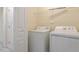 Functional laundry room featuring a washer, dryer, and ample storage space with shelving for added convenience at 135 Cedar Elm Rd, Durham, NC 27713