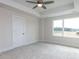 Bright bedroom features plush carpet, recessed ceiling, fan, and large windows with wooded views at 14 Relaxing Way, Pittsboro, NC 27312