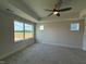 Spacious bedroom with plush carpet, neutral paint, tray ceiling, and ample natural light from multiple windows at 14 Relaxing Way, Pittsboro, NC 27312