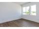 Bedroom with wood flooring and views of the community beyond the home at 14 Relaxing Way, Pittsboro, NC 27312