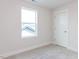 Bedroom featuring soft carpet, bright window and white door at 14 Relaxing Way, Pittsboro, NC 27312