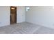 Bedroom featuring neutral carpet, a white door to the ensuite bathroom and crisp white trim at 14 Relaxing Way, Pittsboro, NC 27312