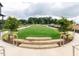 Serene common area with stone steps, a lush lawn, and mature trees offering a peaceful retreat at 14 Relaxing Way, Pittsboro, NC 27312