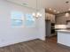 Dining area with view of kitchen and stylish chandelier and wood floors at 14 Relaxing Way, Pittsboro, NC 27312