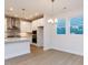 Bright dining area with pendant lighting, large windows, and views of the modern kitchen at 14 Relaxing Way, Pittsboro, NC 27312