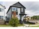 Modern two-story home with black and gray siding, landscaped yard, and inviting front entrance at 14 Relaxing Way, Pittsboro, NC 27312