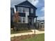Modern two-story home featuring a striking black and gray color scheme and manicured front yard at 14 Relaxing Way, Pittsboro, NC 27312