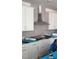 Installers putting the finishing touches on the cabinets and tile work in kitchen at 14 Relaxing Way, Pittsboro, NC 27312