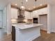 Modern kitchen with white cabinets, stainless steel appliances, and a center island with sink at 14 Relaxing Way, Pittsboro, NC 27312