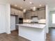 Modern kitchen with gray cabinets, stainless appliances, island and wood floors at 14 Relaxing Way, Pittsboro, NC 27312