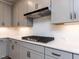Kitchen features gas range and white backsplash and countertops at 14 Relaxing Way, Pittsboro, NC 27312