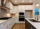 Well-equipped kitchen featuring white cabinets, stainless steel appliances, and modern lighting at 14 Relaxing Way, Pittsboro, NC 27312