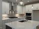 Kitchen featuring white cabinets, a large island with quartz counters, and stainless steel appliances at 14 Relaxing Way, Pittsboro, NC 27312
