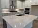 Kitchen featuring white cabinets, a large island with quartz counters, and stainless steel appliances at 14 Relaxing Way, Pittsboro, NC 27312