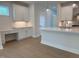 Bright kitchen boasts white cabinets, island with quartz countertops, and stainless steel appliances at 14 Relaxing Way, Pittsboro, NC 27312