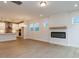 Open living room with hardwood floors, fireplace, and bright views of the modern kitchen at 14 Relaxing Way, Pittsboro, NC 27312