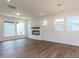 Open living room with hardwood floors, fireplace, and an abundance of natural light at 14 Relaxing Way, Pittsboro, NC 27312