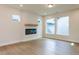 Open living room features hardwood floors, a fireplace, recessed lighting, and large windows at 14 Relaxing Way, Pittsboro, NC 27312